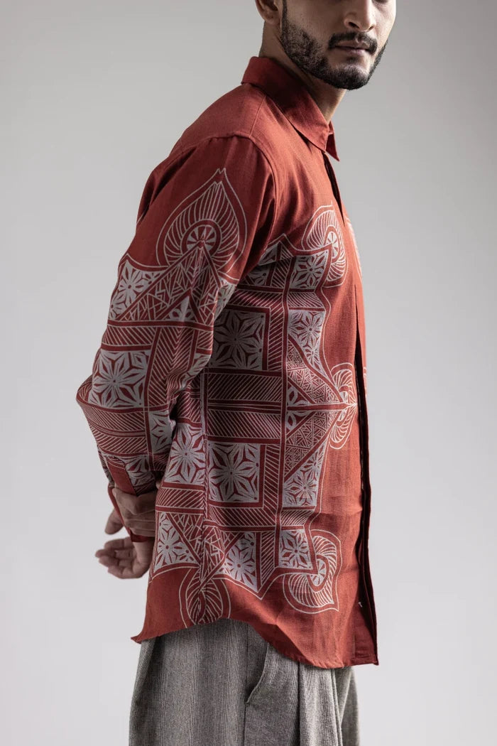 Man wearing the Terra Rangoli shirt, waist-up side view showing the rangoli motifs along the sleeve