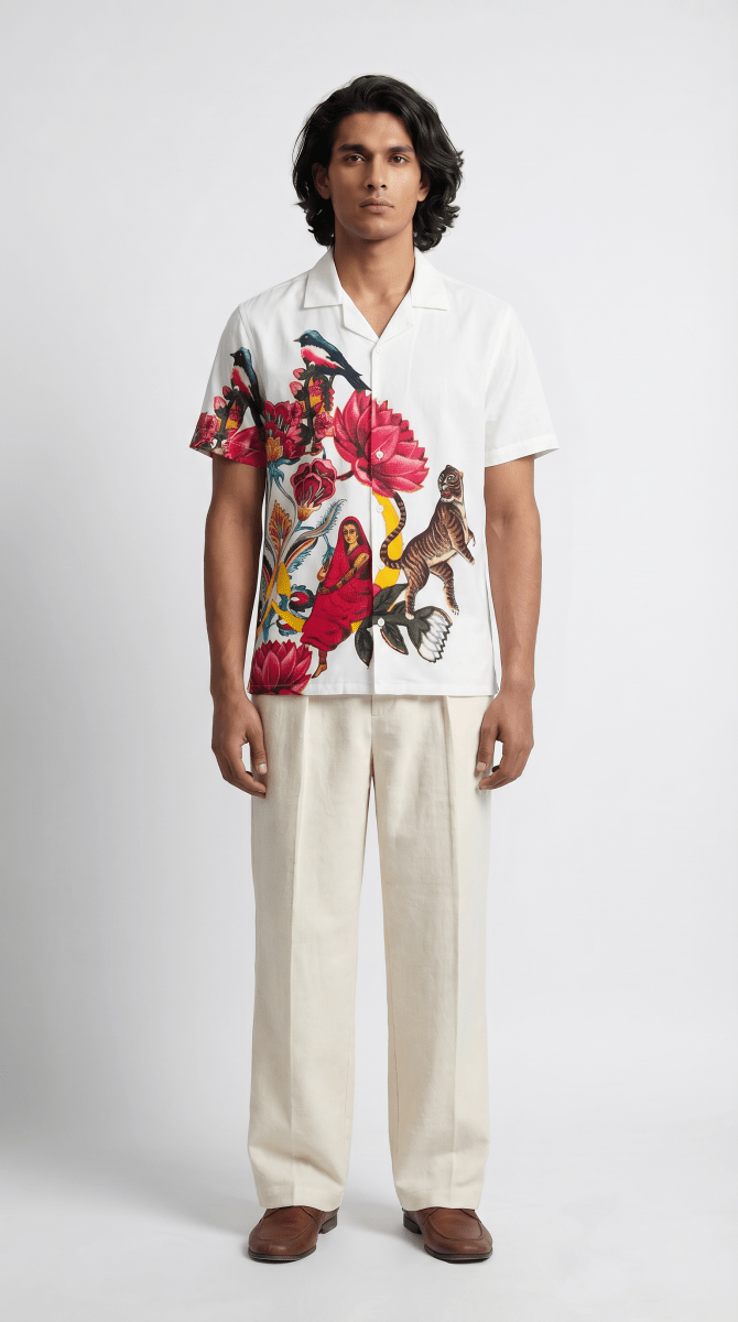 Man wearing the white 16 Bit Retro Art shirt with cream trousers, front view, floral artwork on the left side