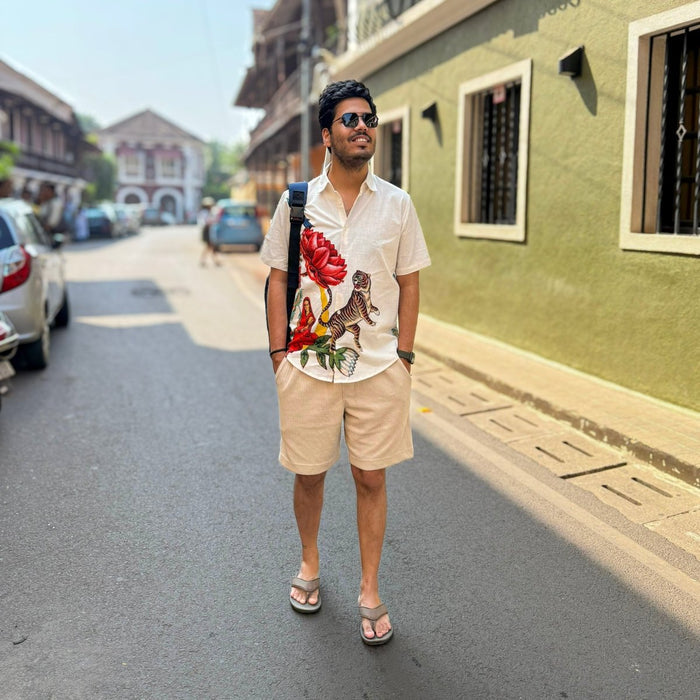 Man wearing the 16 Bit Retro Art shirt with beige shorts, standing on a street, front view