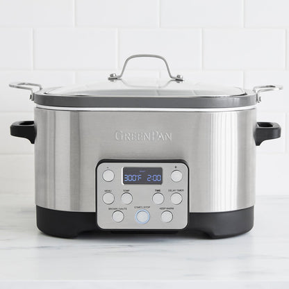 Stainless steel 7-in-1 slow cooker with in-pot browning feature on a white kitchen countertop.
