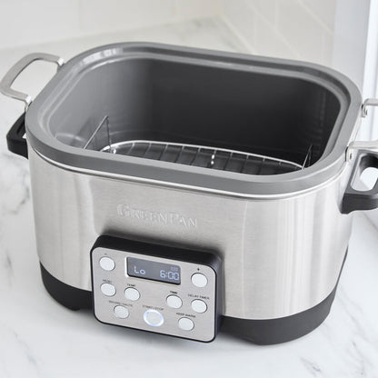 Stainless steel 6-quart slow cooker with in-pot browning on a white countertop.
