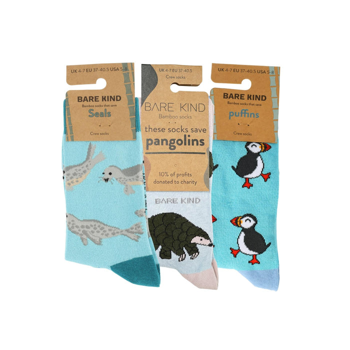 Three pairs of socks with animal illustrations and 'Bare Kind' packaging on a white background.