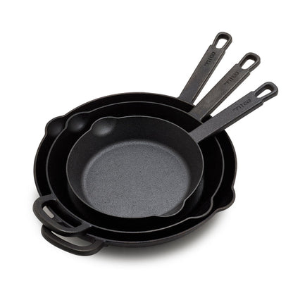The Bobby Flay by GreenPan 8", 10" and 12" Cast Iron Frypan Set includes three nested pans, each with a roomy cooking surface and long handle with a hanging hole—heirloom-quality cast iron skillets made for everyday use.