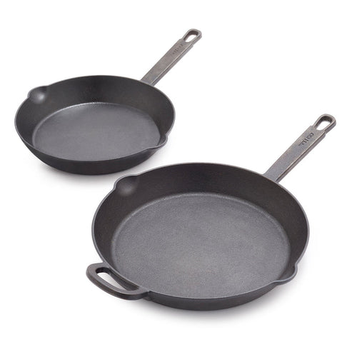 The Bobby Flay by GreenPan 8" and 10" Cast Iron Frypan Set features two black skillets with long handles, one with an extra small handle. These heirloom-quality pans are empty on a white background—ideal for any modern kitchen.