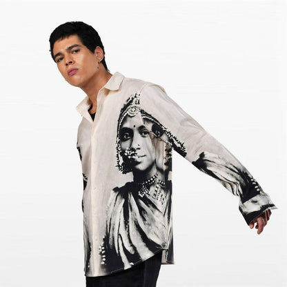 Man wearing the CM resort shirt, leaning in, arm stretched out showing the sleeve portrait print