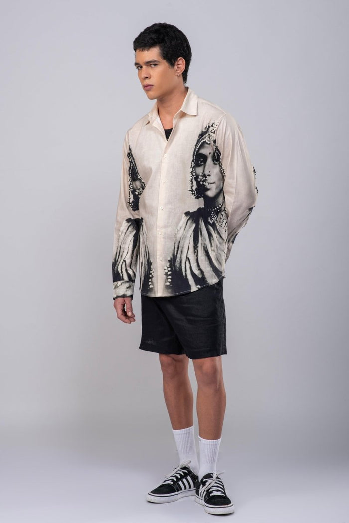 Man wearing the CM resort shirt with black shorts, full length three-quarter view, hands behind his back