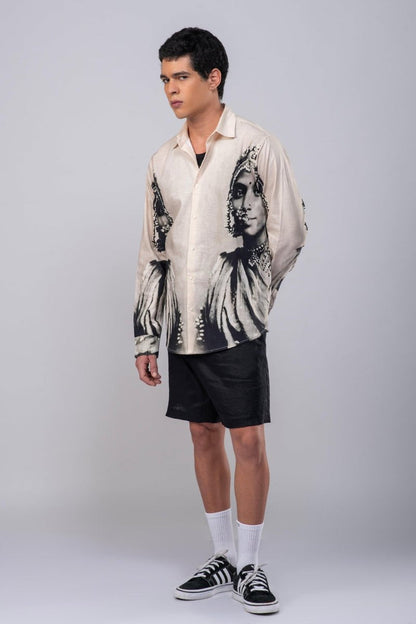 Man wearing the CM resort shirt with black shorts, full length three-quarter view, hands behind his back