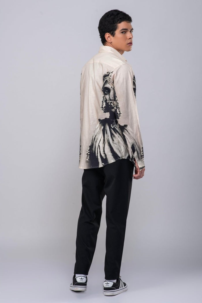 Man wearing the CM resort shirt with black trousers, full length back view, looking over his shoulder