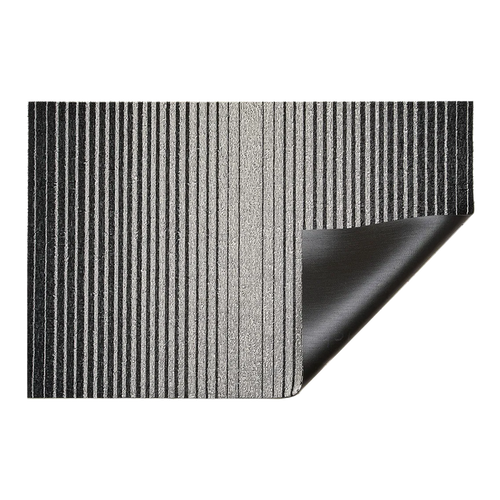 Inspired by the sharp contrast and mesmerizing motion of a cascading row of dominoes, the variegated stripes of this easy-care floor mat are at once dynamic and serene.
