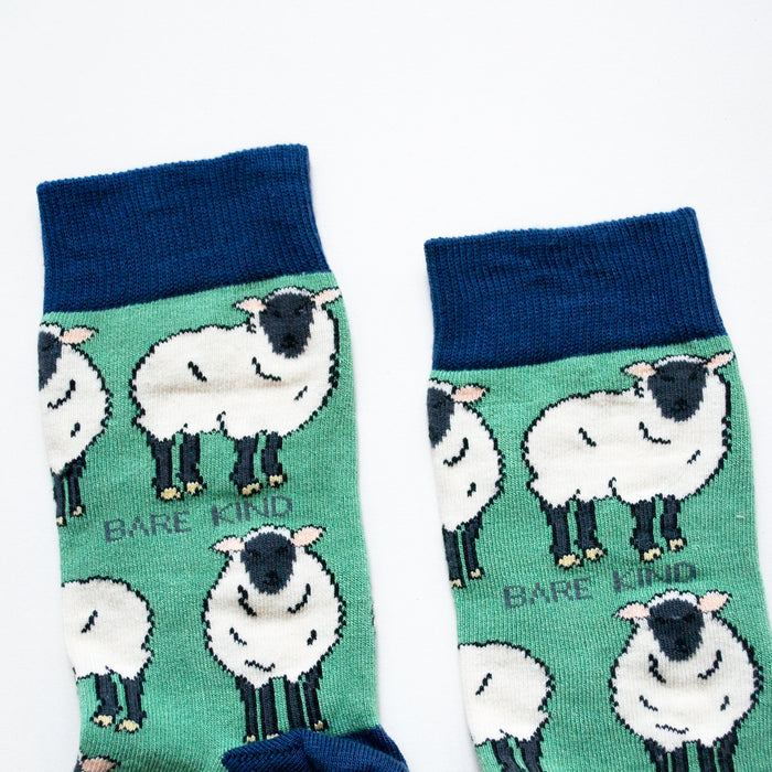 cuff closeup flat lay of green sheep socks with navy cuff