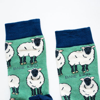 cuff closeup flat lay of green sheep socks with navy cuff
