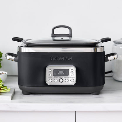 Black slow cooker with digital display on a white countertop