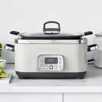 Cream slow cooker with digital display on a white countertop