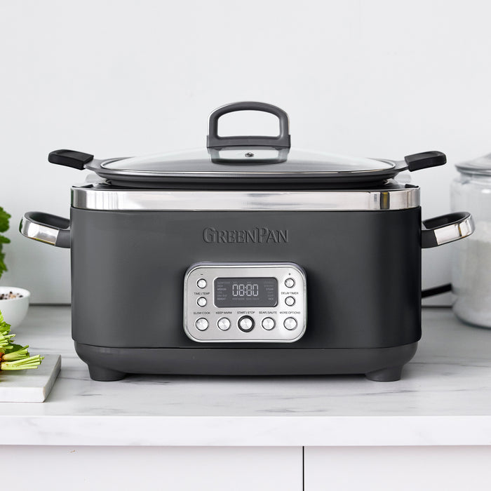 Gray slow cooker with digital display on a white countertop