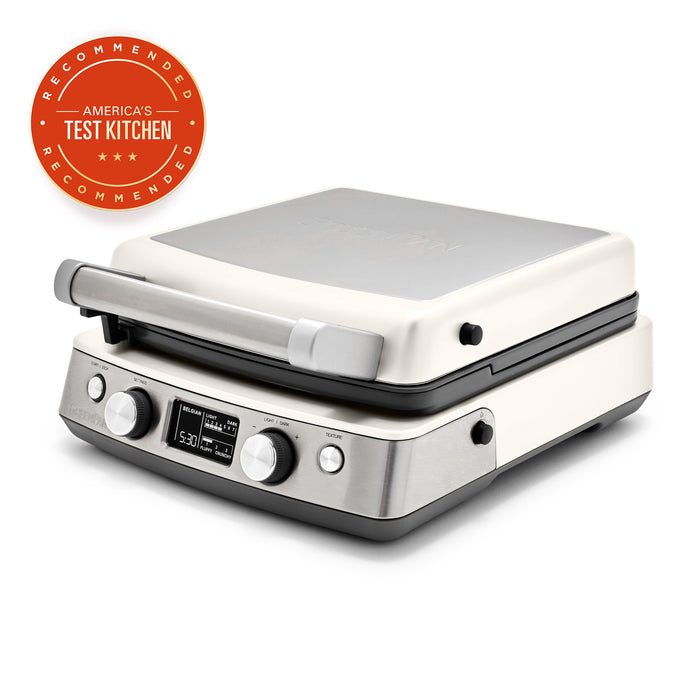 Cream ceramic 4-square waffle maker with digital display, next to an Americas Test Kitchen badge.