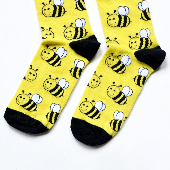 toe closeup flat lay of black and yellow bee bamboo socks