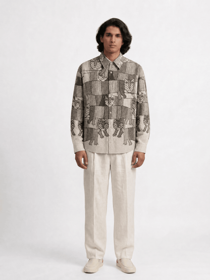 Man wearing the Gond Forest shirt with cream trousers, front view
