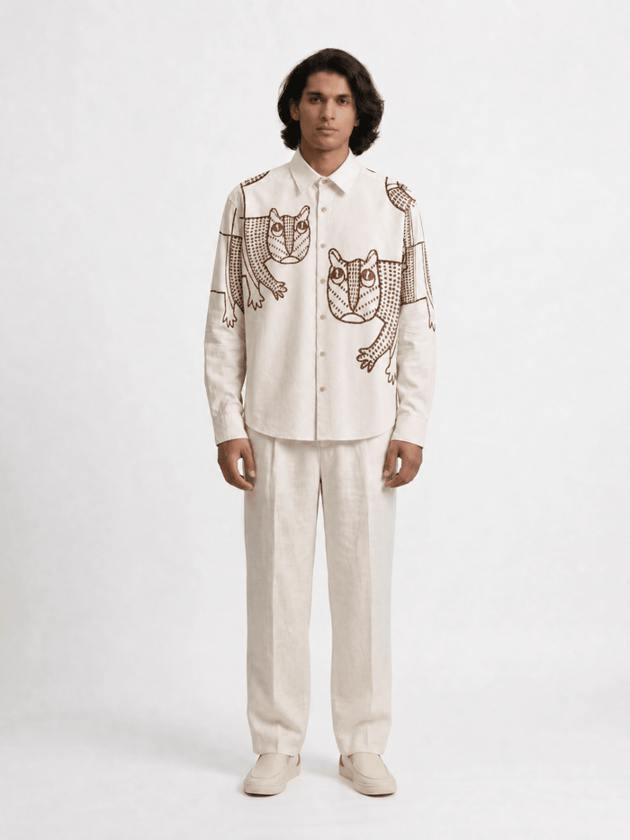 Man wearing the off white Gond Tiger shirt with cream trousers, full length front view
