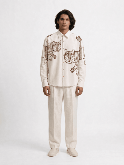 Man wearing the off white Gond Tiger shirt with cream trousers, full length front view