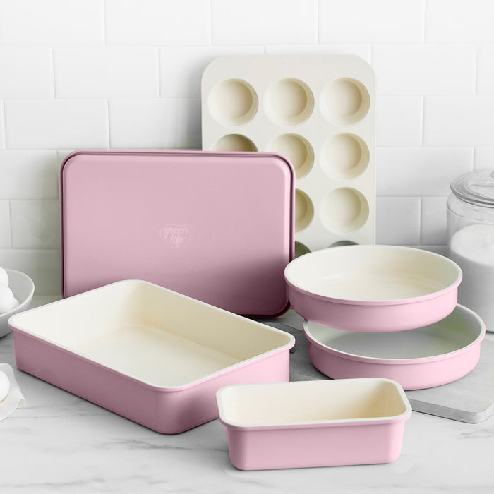 Set of pink bakeware on a kitchen counter
