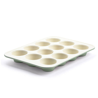 12-cup ceramic muffin pan in sage green with a light cream interior, shown from an angled view.