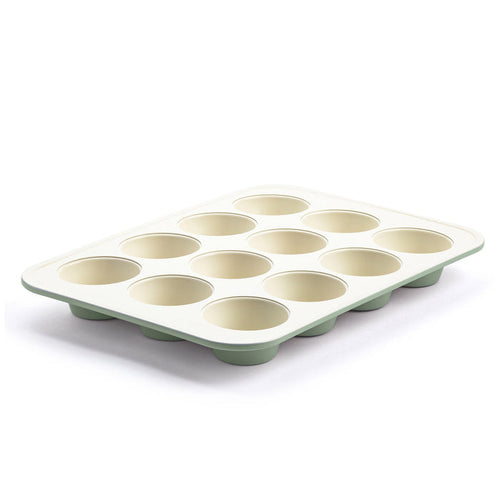 12-cup ceramic muffin pan in sage green with a light cream interior, shown from an angled view.