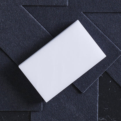 GreenPan accessory kit on layered black textured sheets, resembling stacked cookware on a dark background.