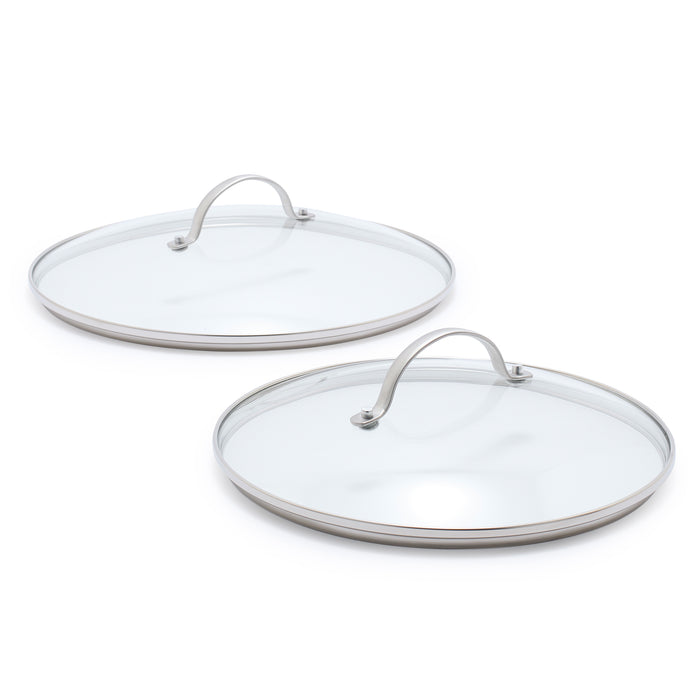 Two glass lids with stainless steel handles on a white background