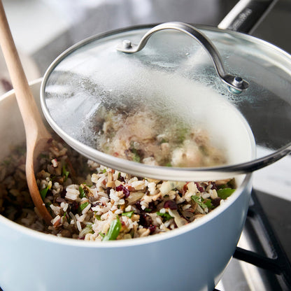 Glass GreenPan lid covers pot of rice and vegetables on stove; set includes two clear lids, 8-inch and 10-inch sizes.