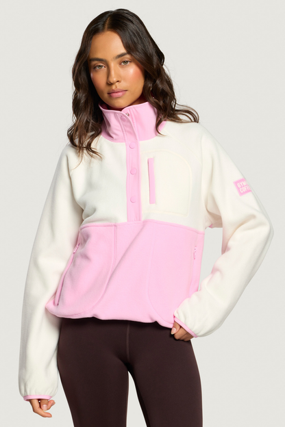 Model wearing Gym+Coffee Snap Polar Fleece Pink Blossom against a plain background Shop Gym+Coffee at Dotique