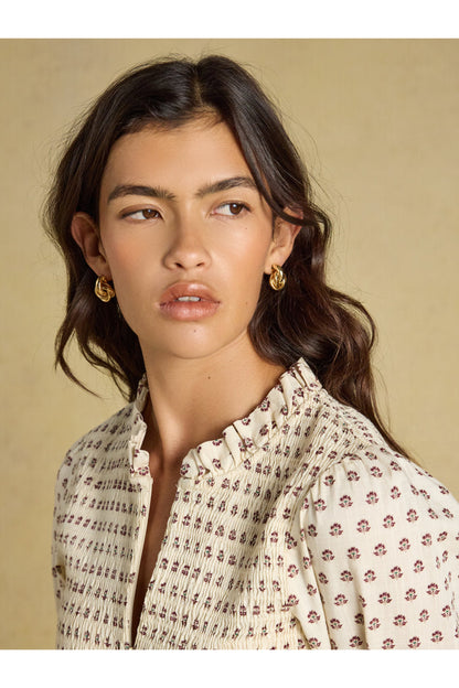 Shop the Joules Zoe Blouse in Cream Ditsy at Dotique. A 100% cotton blouse with a smocked bodice, frill collar, adjustable zip and long sleeves.