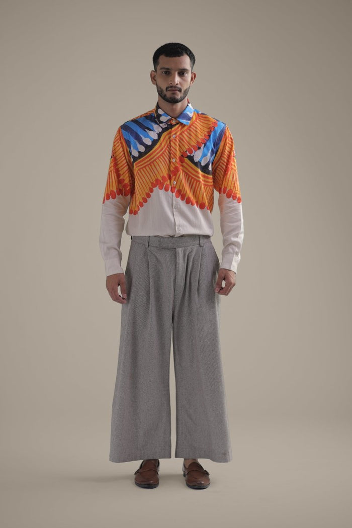 Man wearing the off white Kalighat Fire shirt with wide grey trousers, full length front view