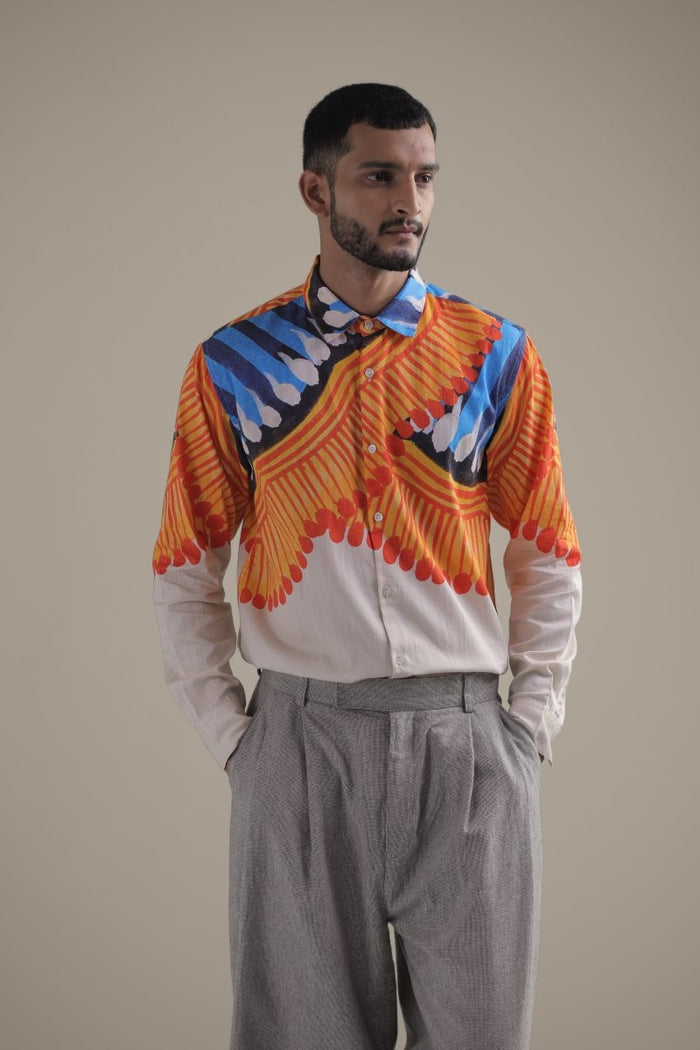 Man wearing the Kalighat Fire shirt with grey trousers, waist-up three-quarter view, looking to the side