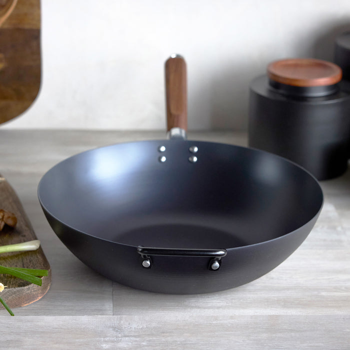 Black wok on a kitchen counter