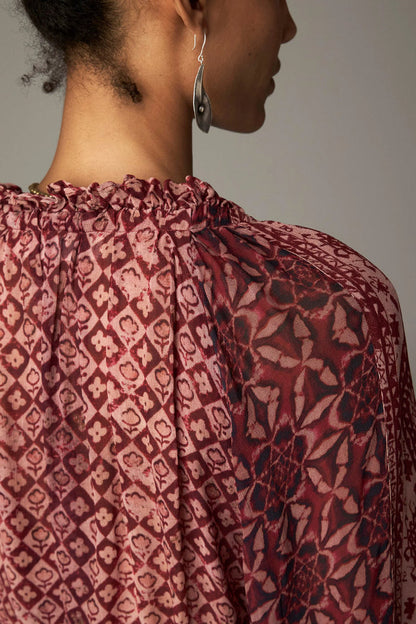 Shop the Maison Hotel Hannah Blouse in Wine at Dotique. A printed blouse with a ruffled neckline, tassel ties and voluminous sleeves.