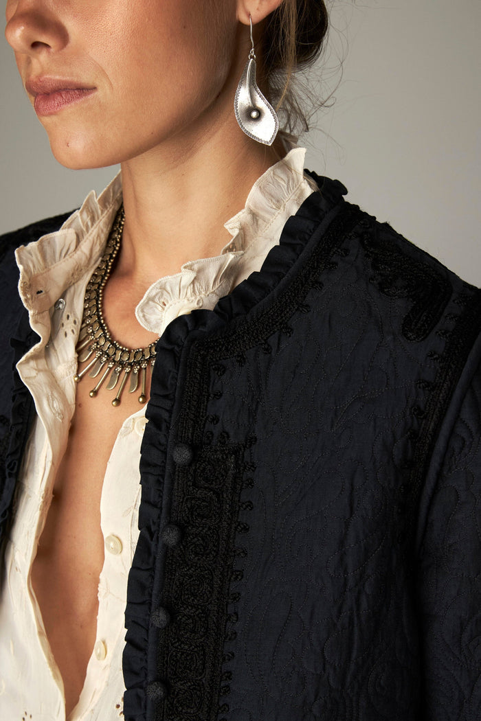 Shop the Maison Hotel Paco Jacket in Ceniza at Dotique. A cropped collarless jacket with embroidered trims, an open front and patch pockets.