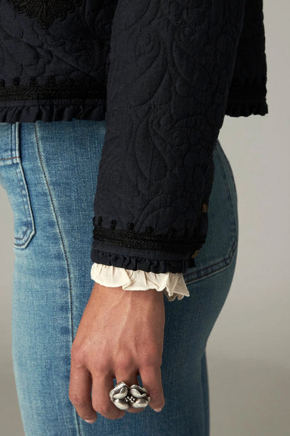 Shop the Maison Hotel Paco Jacket in Ceniza at Dotique. A cropped collarless jacket with embroidered trims, an open front and patch pockets.