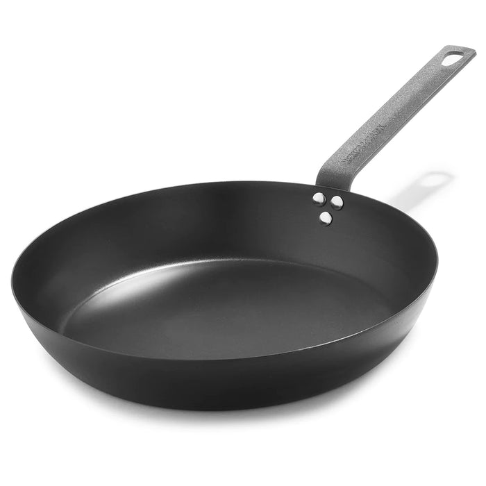 Carbon steel 12-inch frypan with a long handle and three rivets on a white background.