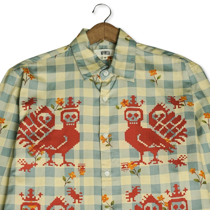 Close view of the Mori Checks shirt collar and red bird motifs on the green check front