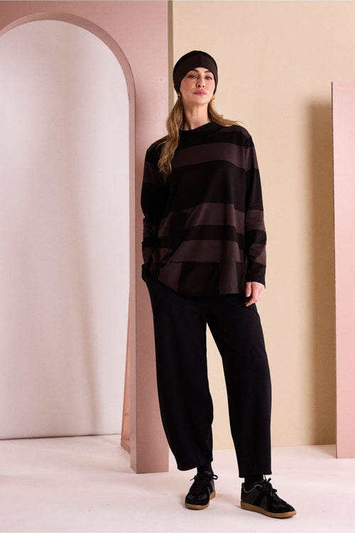 Naya NAW26144 Balloon Shaped Trouser with Darts at Hem Black styled on model. Shop Naya at Dotique