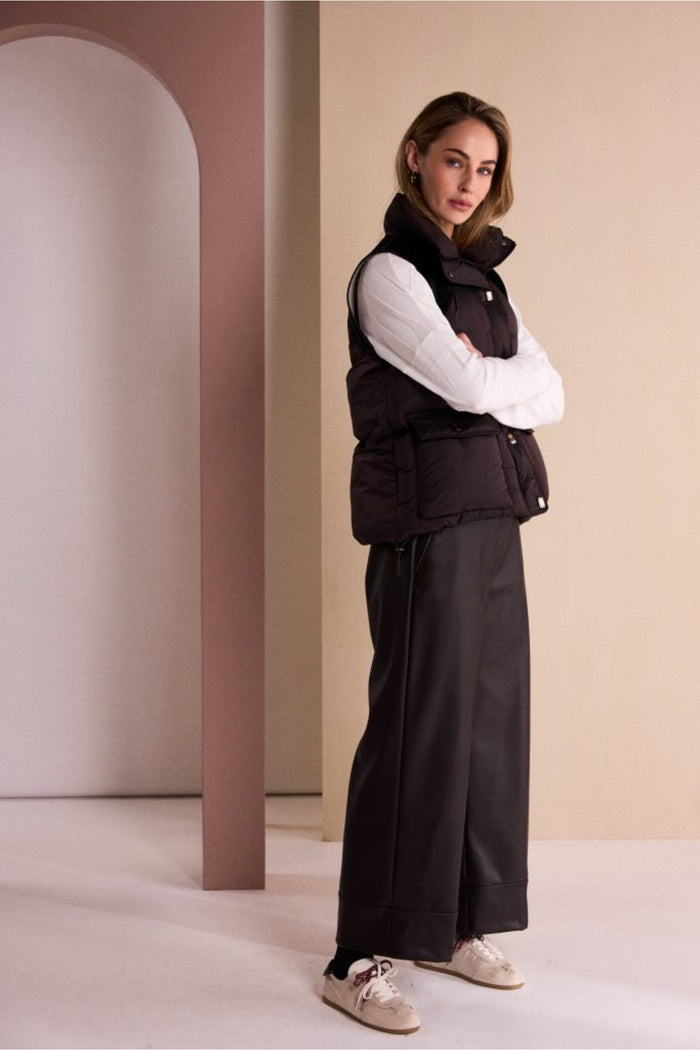 Naya NAW26176 Brown Quilted Waistcoat With Drawstring Hem With Contrast Shoulder worn by model Shop Naya at Dotique