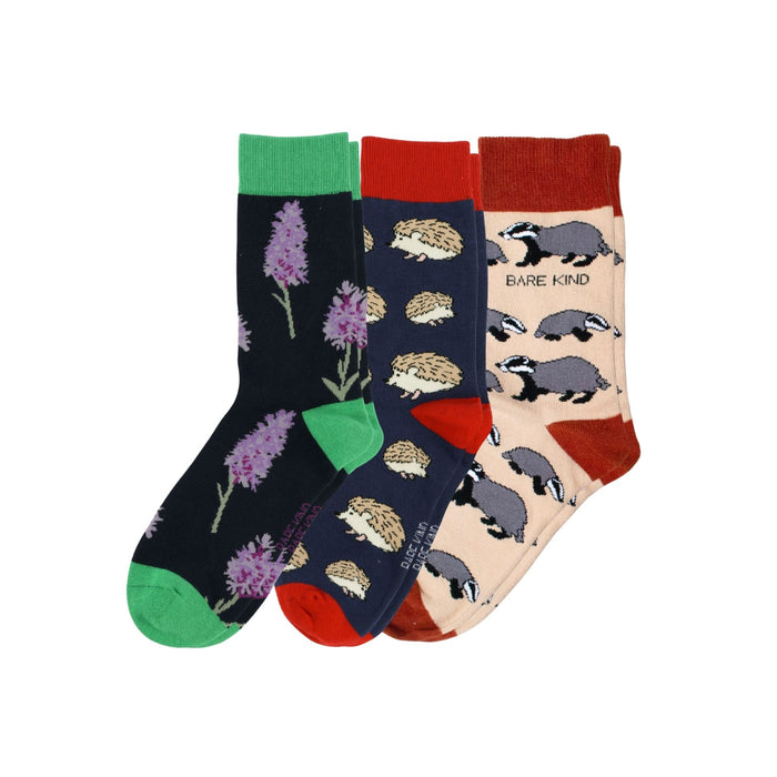 Three pairs of socks with different patterns on a white background