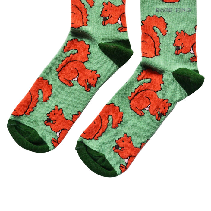 toe closeup flat lay of green bamboo socks with woven red squirrel design