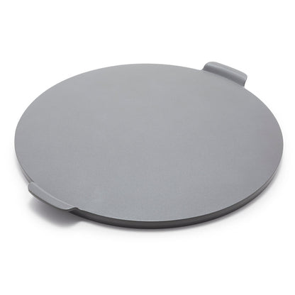 Gray round pizza baker with two small handles, ceramic material, shown on a white background.