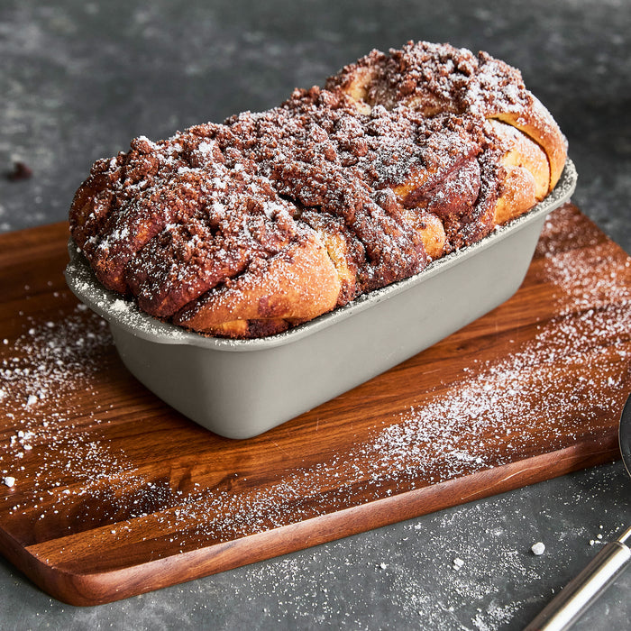 Chocolate babka in a taupe ceramic nonstick loaf pan.