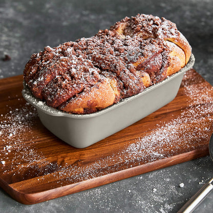 Chocolate babka in a taupe ceramic nonstick loaf pan.