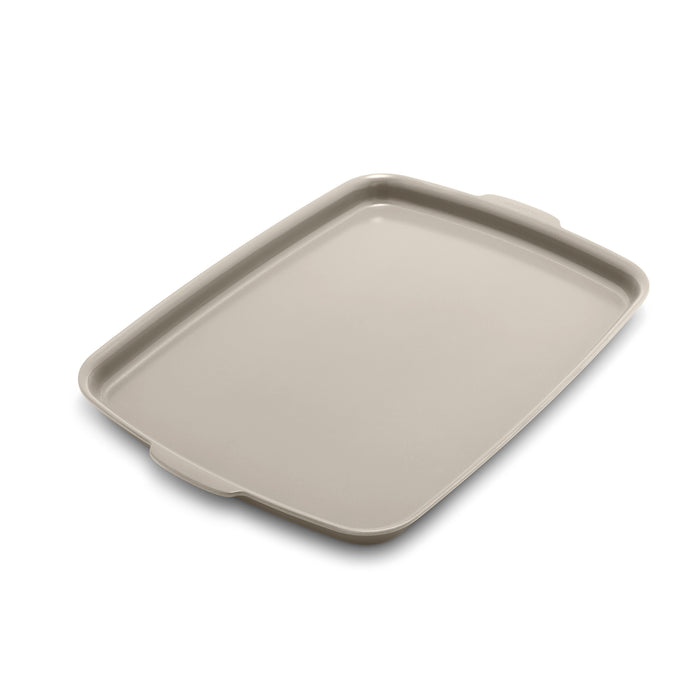 Taupe ceramic nonstick half sheet pan with raised edges, 18 by 13 inches.