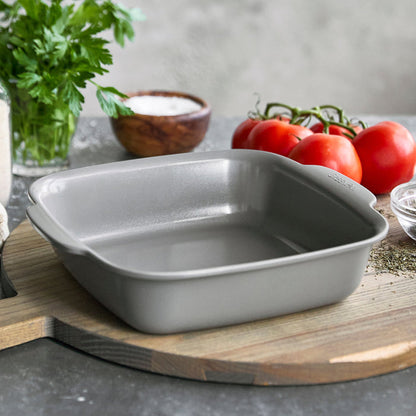 Gray ceramic nonstick 2-piece cake pan set on a wooden board with fresh ingredients nearby.