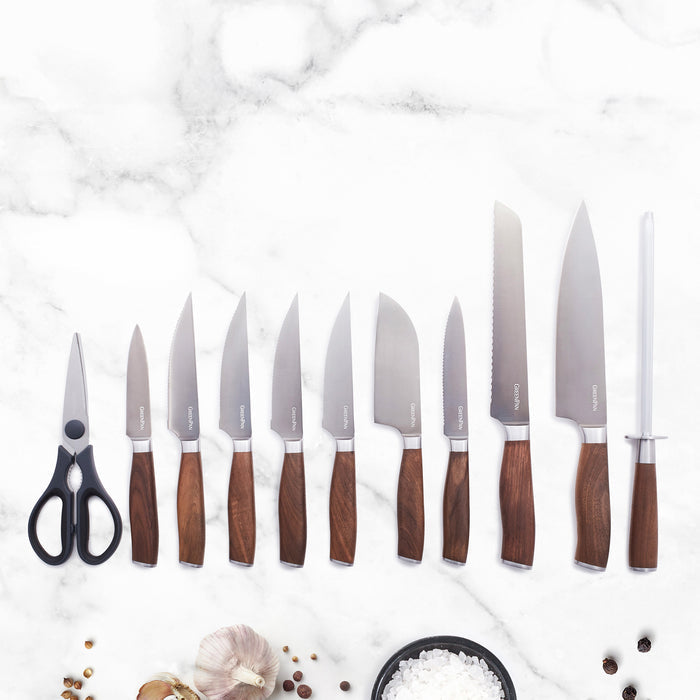 12-piece knife block set with walnut handles displayed on a marble countertop.