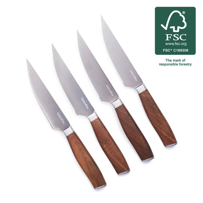 Set of four steak knives with walnut handles, arranged diagonally on a white background.